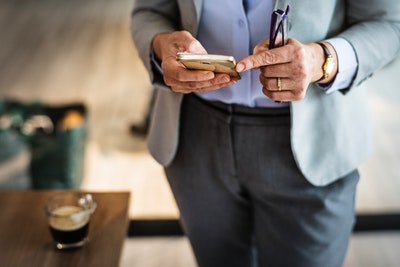 man using smartphone to send sms